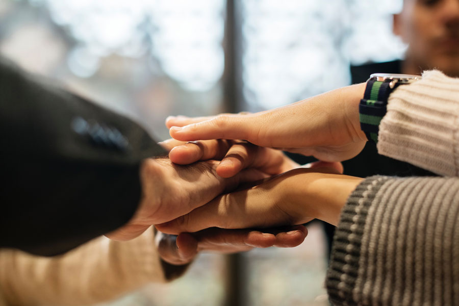 team members hands - develop highly accountable people with truby achievements