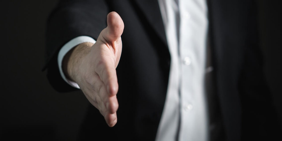 extended handshake representing effective hiring - from Effective Hiring – Nine Questions to Hire the Right Person for the Job article by Truby Achievements