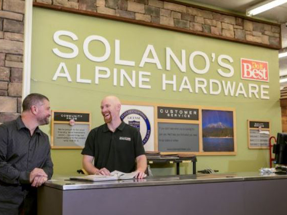 photo of mike solano talking to one of his employees in the Somanos do it best alpine hardware store - happy client of the truby achievements, a leading source for leadership and management training