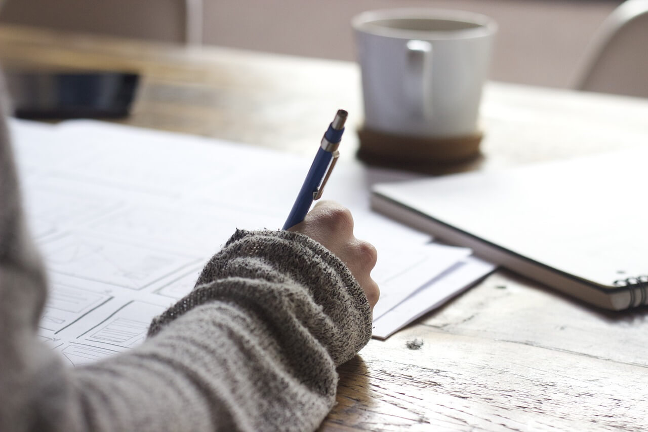 woman taking a quiz at a desk - for personality type assessment on the truby achievements website