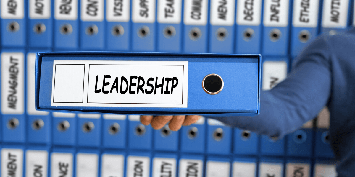 work binders with one held up with words leadership on spine - featured image for Truby Achievements blog post titled 7 key leadership skills