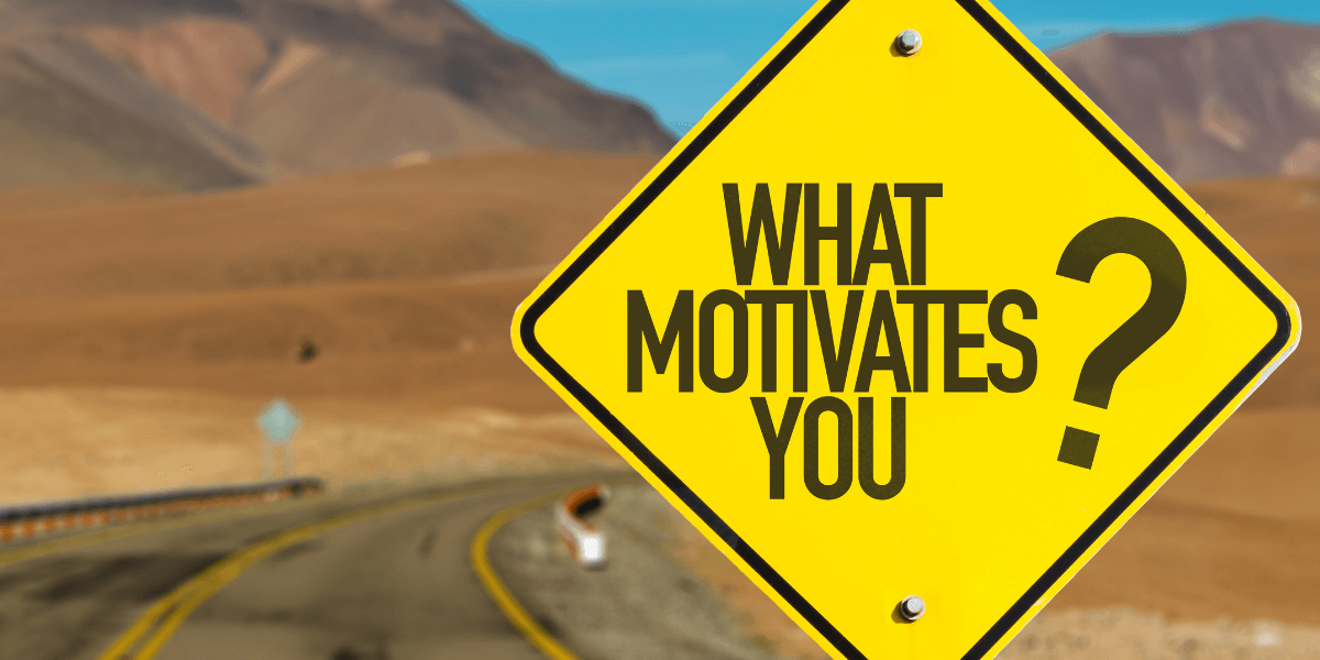 yellow road sign that says "what motivates you?" - featured image for article from truby achievements - How to Improve Motivation by Understanding How Your Subconscious Ticks