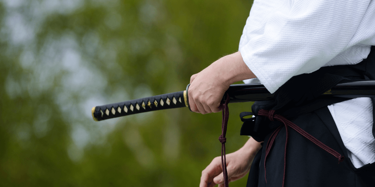 aikido master holding a sword - featured image for truby achievements article - Stop Negative Thoughts By Mental Martial Arts!