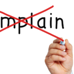 writing on a clear board - complain with a red x across - featured image for can't complain blog by truby achievements