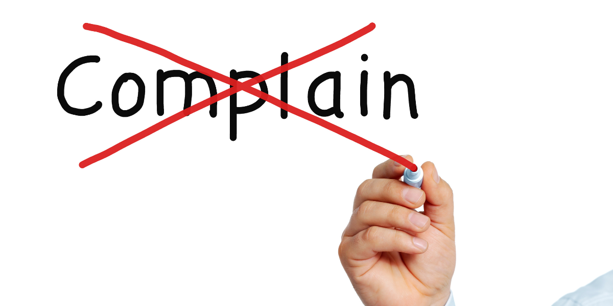 writing on a clear board - complain with a red x across - featured image for can't complain blog by truby achievements