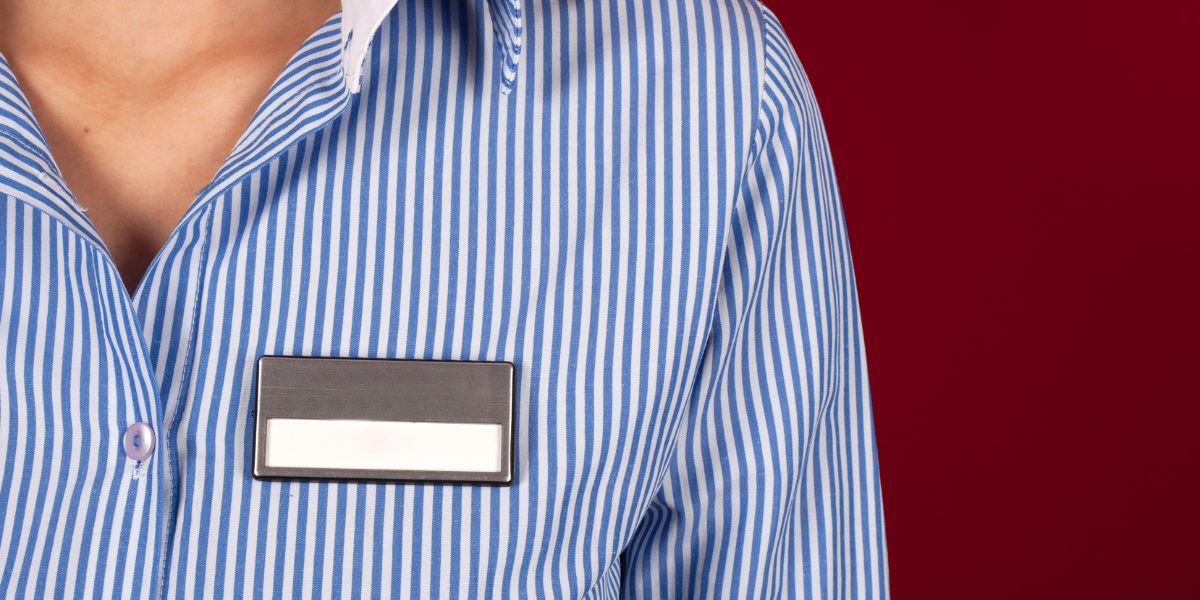 woman in blue and white striped shirt with a blank label - featured image for self-labeling blog by truby achievements