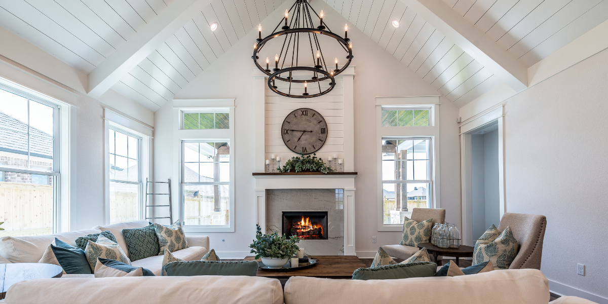 contemporary living room with white walls and tall vaulted ceilings - featured image for changing your environment blog by truby achievements