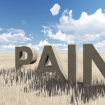 large block letters that say pain in a wheat field - featured image for phantom pain blog by truby achievements